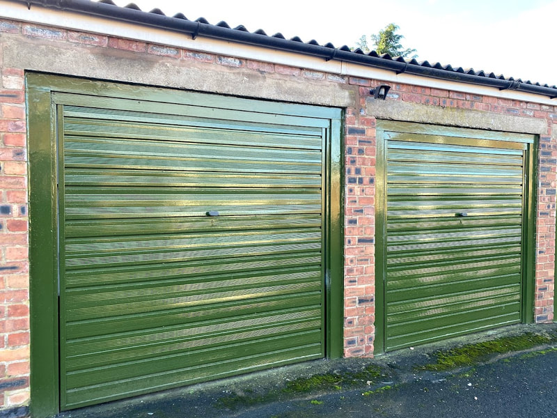 two green lock up garages