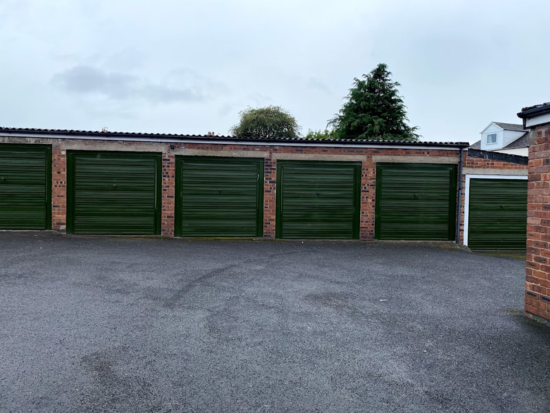 six green lock up garages in a row in carlisle
