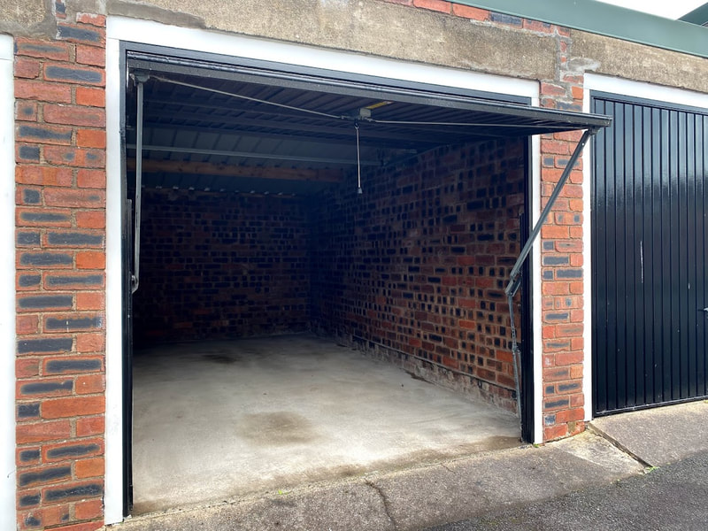 lock up garage with door open showing the inside